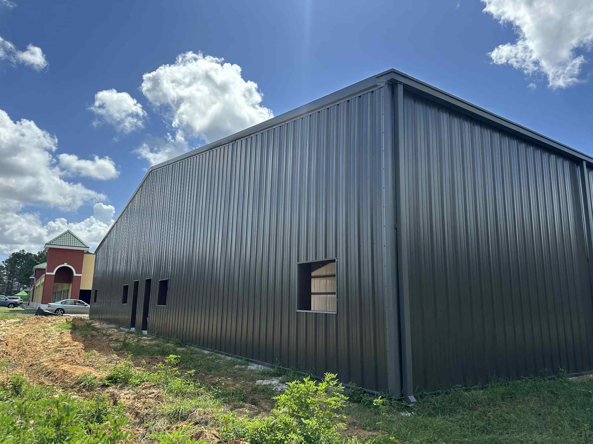Completed commercial dark charcoal metal building exterior