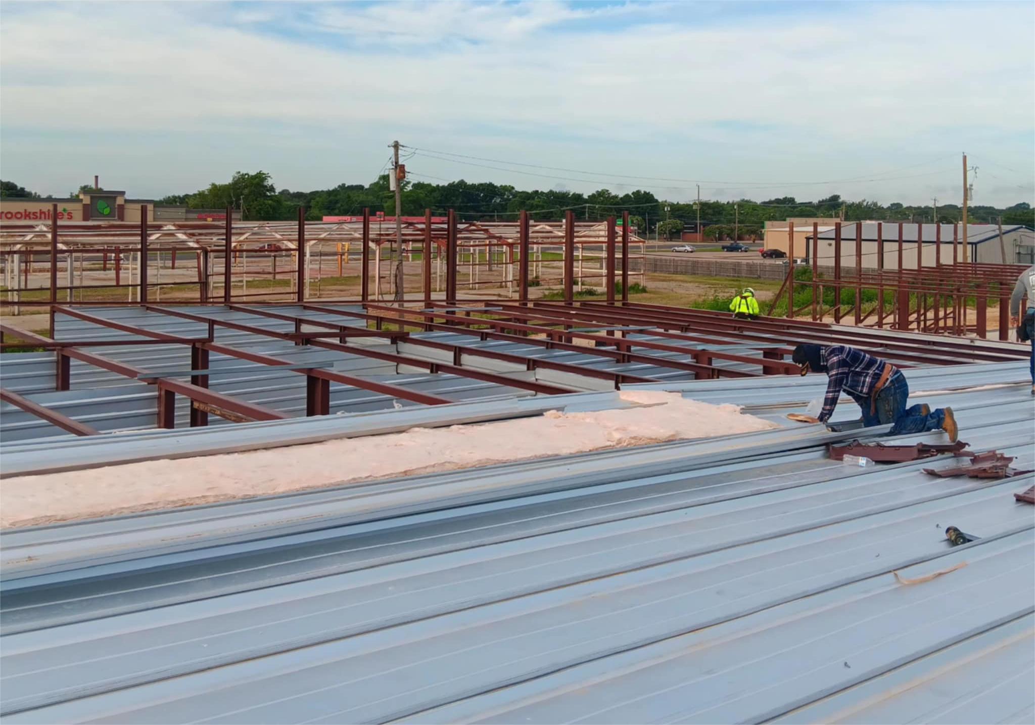MaloSteel crew installing metal roofing panels on an active job site